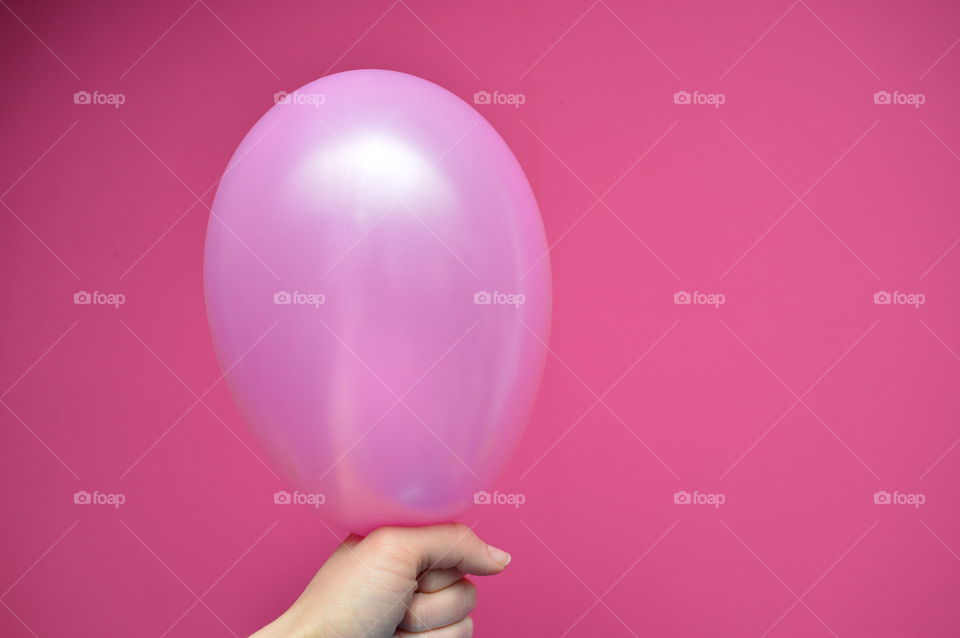 Close-up of hand holding a balloon