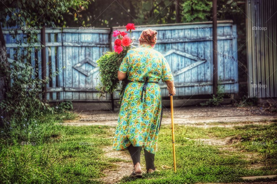 My wife’s sweet grandmother walking to her friend’s house to see her while she was ill in bed. The natural light covering her head and shoulders made this moment magical. Natural light at its best.