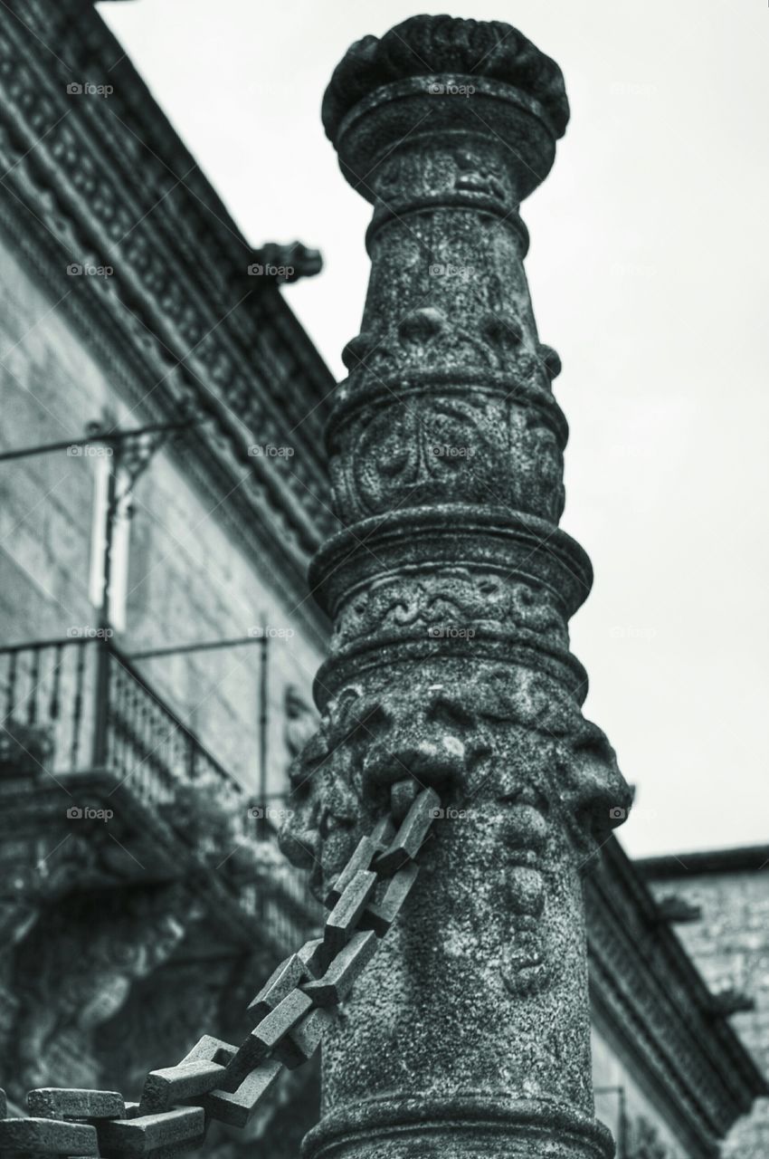 Pillar and chain. Pillar and chain at the entrance to Hostal dos Reis Católicos, the oldest hotel in the world. Santiago de Compostela.