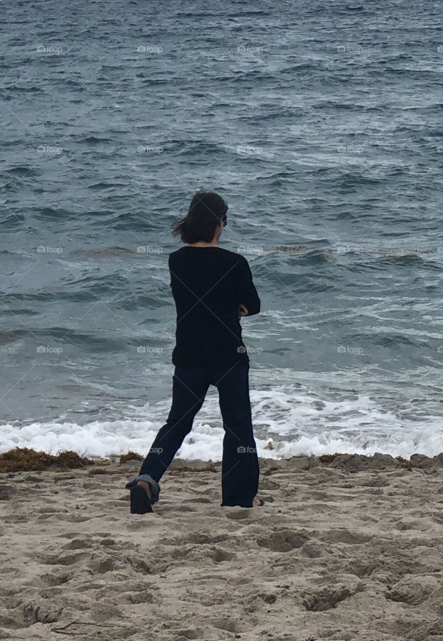 Girl in black on beach 