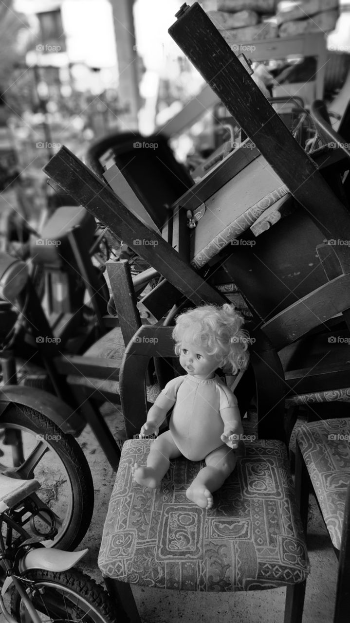 old doll forgotten in a pile of mess