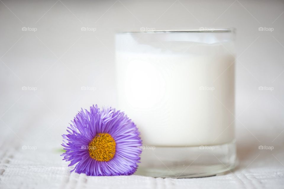 Yogurt in glass and flower