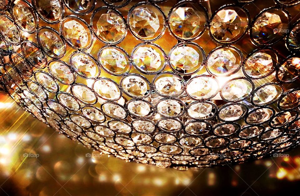 Chandelier covered in glowing circular crystals.