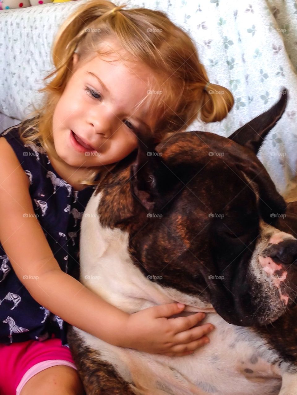 Little girl hugging her dog