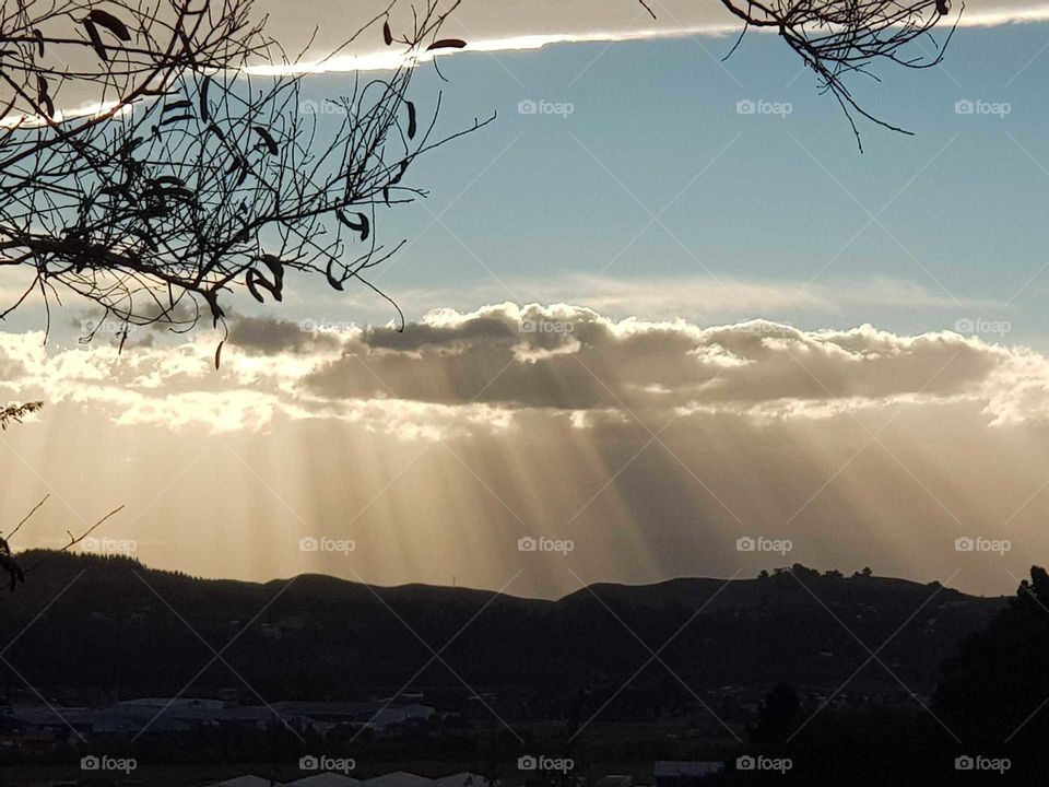 View from my balcony raining in the ranges illuminated by the sun. Amazing natural scene.