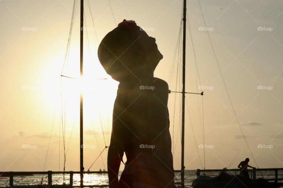 Girl laughing at sunset on the dock