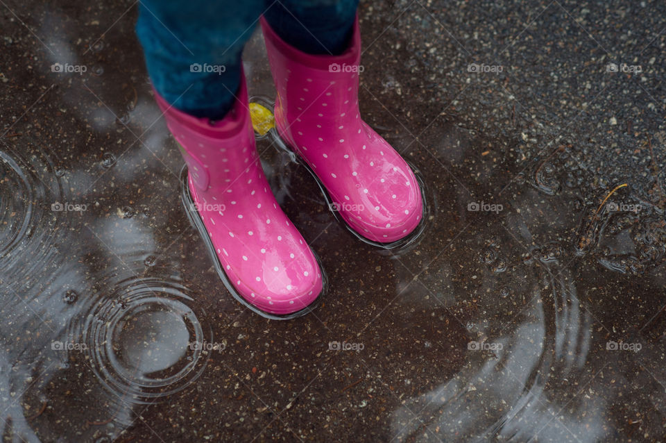 Rubber boots in a puddle