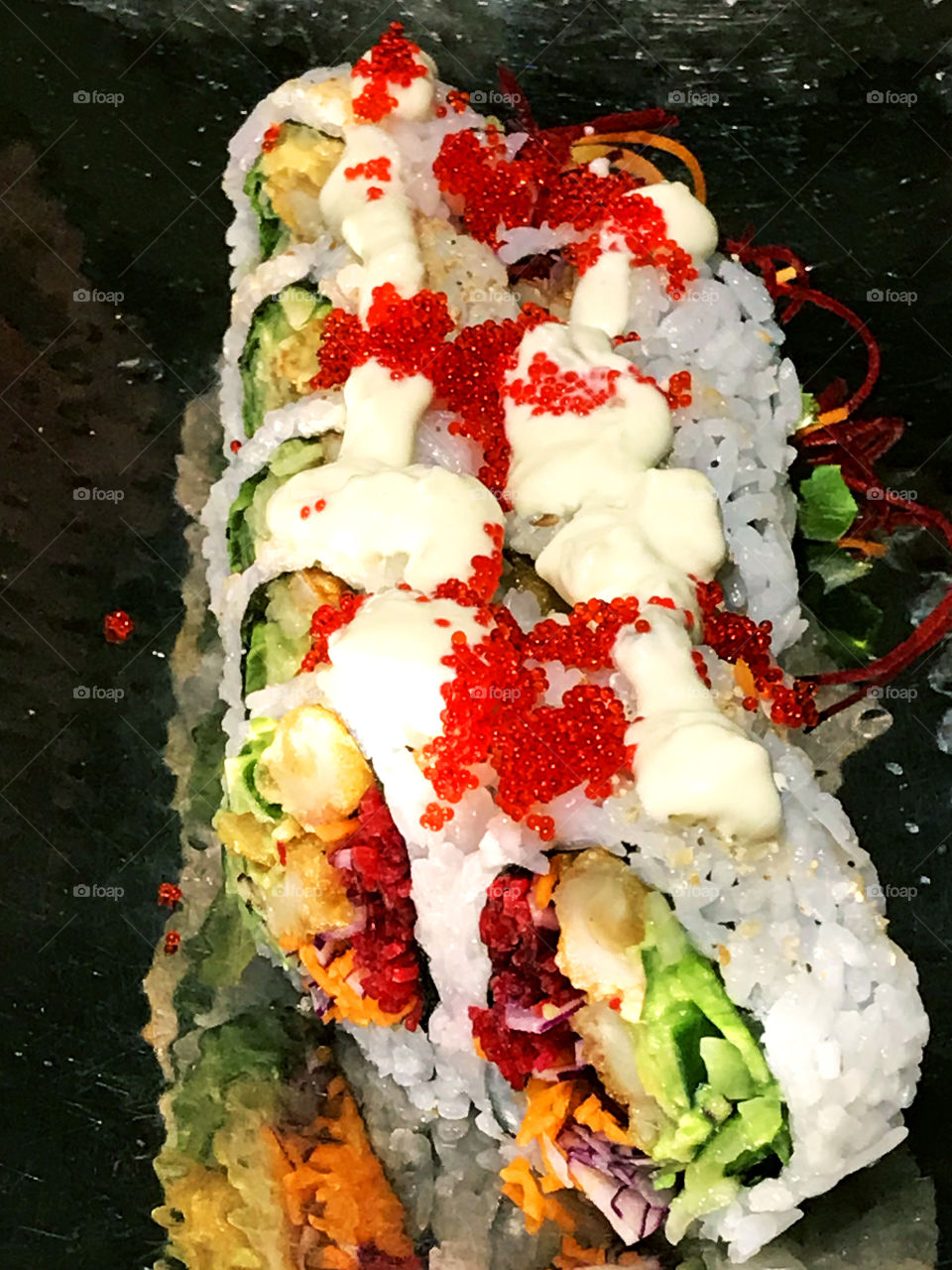 A plate of beautifully presented sushi of tempura prawn, crab, radish, carrots, beets, cucumber, & avocado, rice & nori topped with mayonnaise & fish roe. Celebrating my husbands birthday at our fav sushi restaurant! 🥢