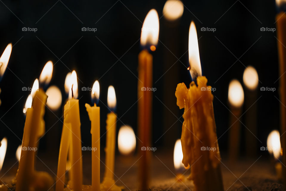 wax candles in an orthodox church.  close up view with bokeh