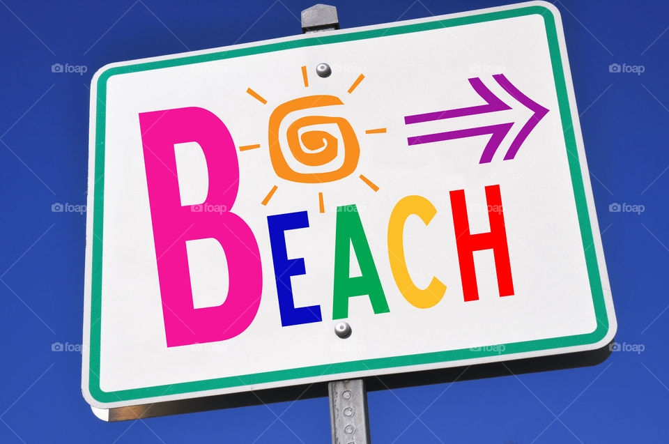 Colorful beach direction sign. 