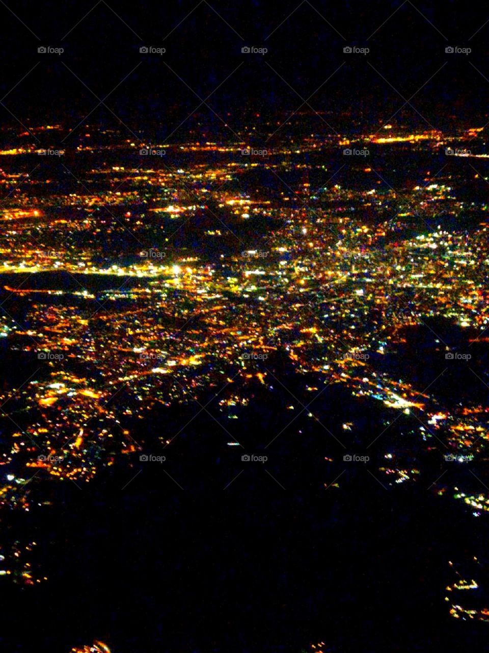 Big city lights from the airplane window. Milan. Italy