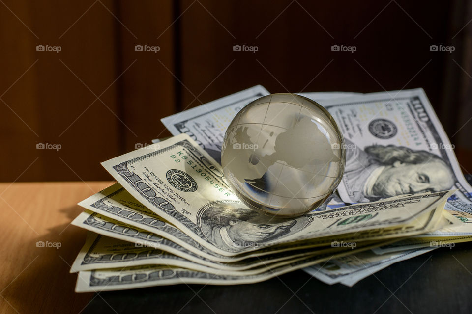 transparent globe on dollars