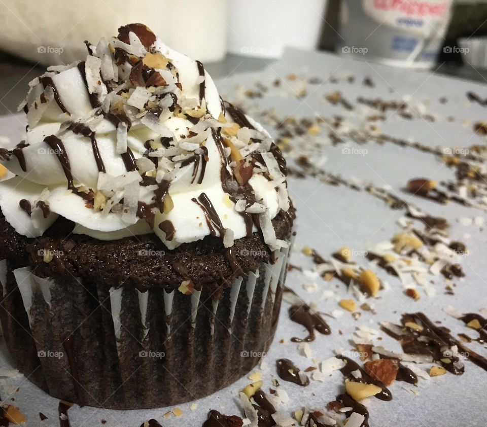Almond Joy Cupcake... chocolate cake with coconut frosting, drizzled chocoaled topped with chopped almonds. 