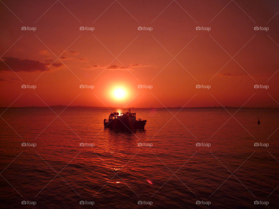 Sunset in red and a boat