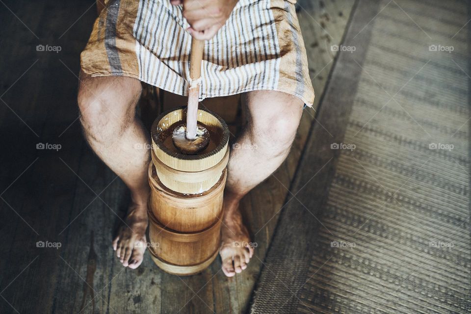 Man making butter with butter churn. Old traditional method making of butter