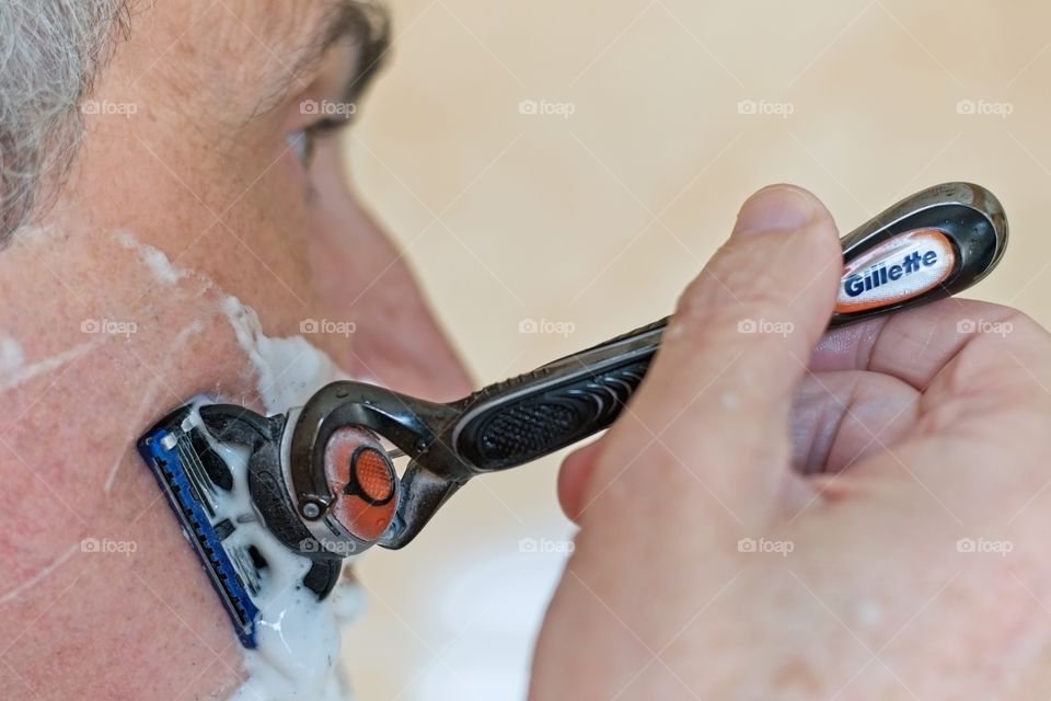 A man shaving in the bathroom