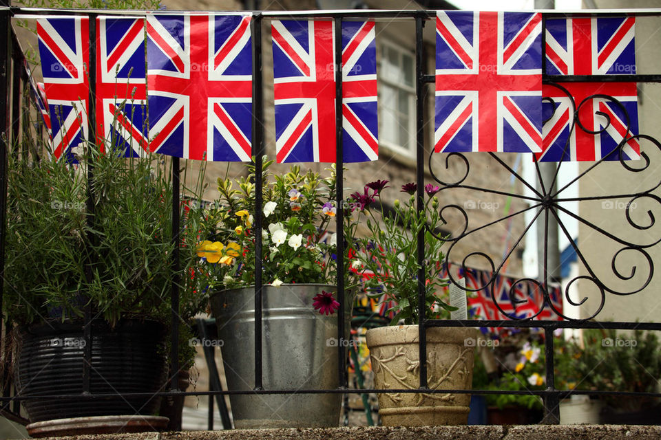 British flags on a town balcony with plants