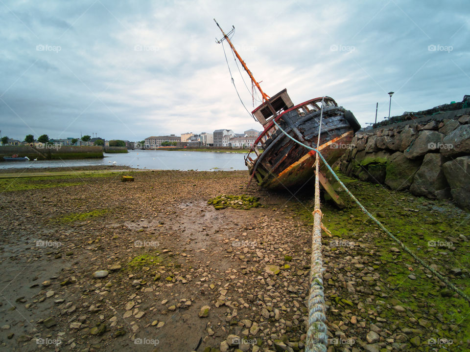 Old ship on the shore of Corrib River in the Galway City