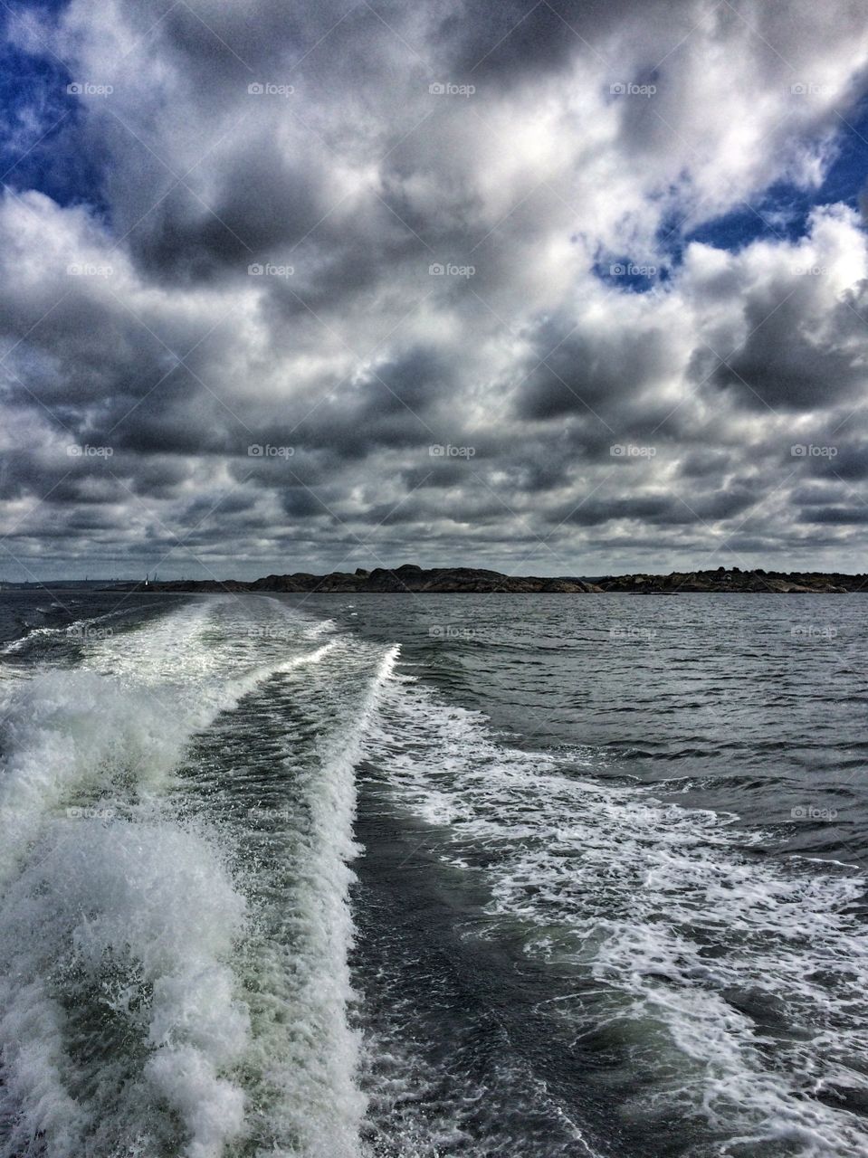 View of water wake and cloudscape