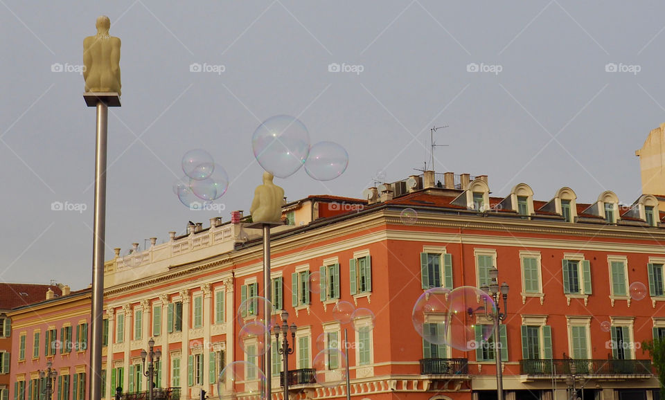 Bubbles in foreground of view of Place Massena in Nice, France.
