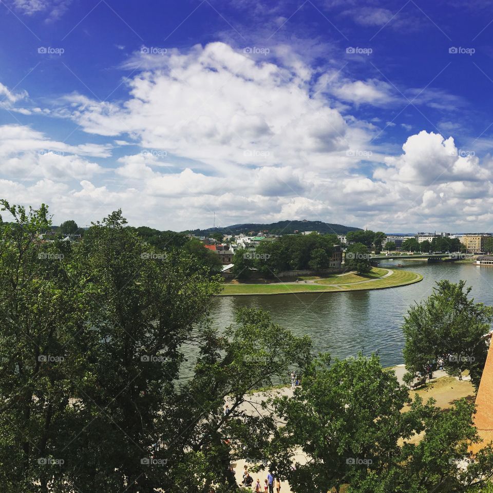 Warm summer day and a cool breeze off the water.   The sky like a painting brilliant and crisp against the green horizon.  This is summer.