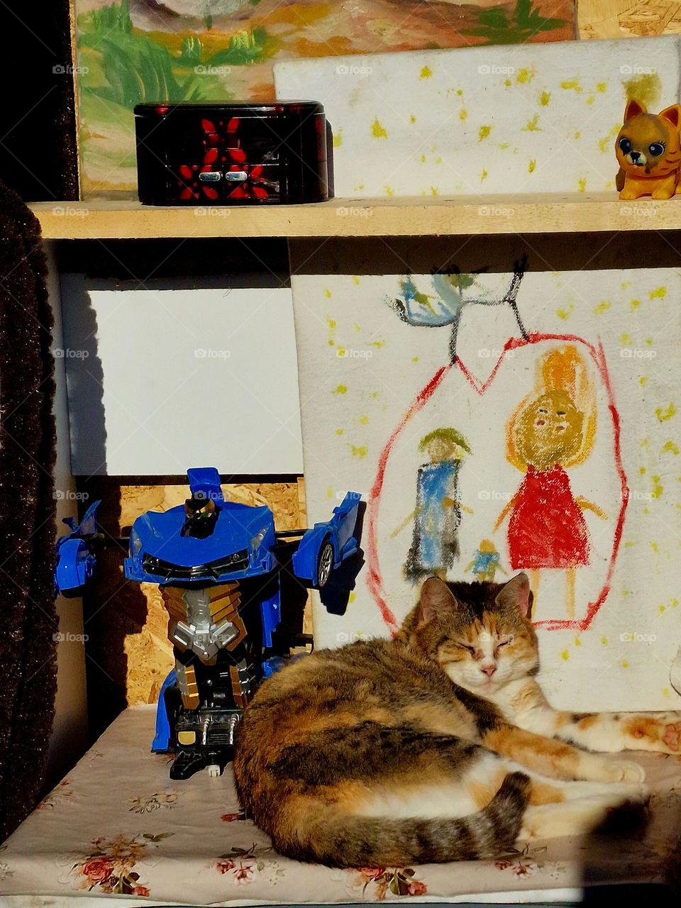 the cat sleeping next to the cartoon family