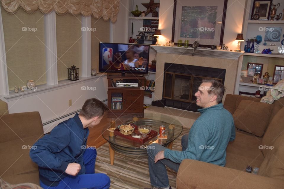 March madness, father and son watching basketball