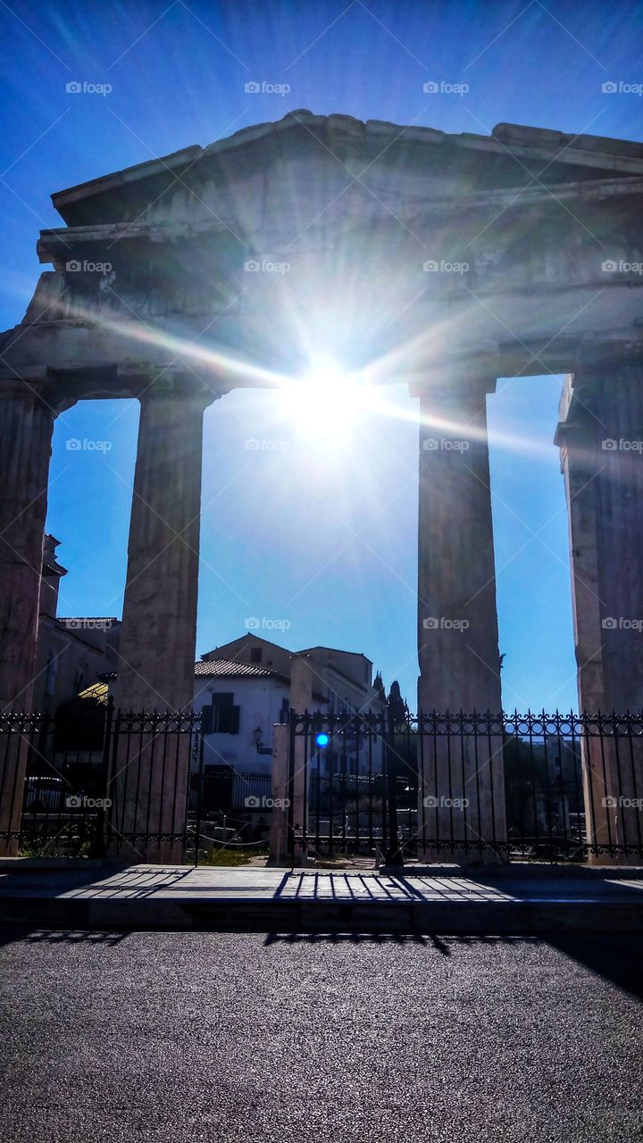 The Gate of Athena Archegetis in Roman Agora in Athens backlit by the sun