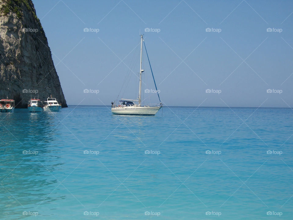 boat in turquoise sea in front of Navagio beach