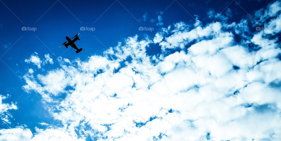 Flying out of the clouds.