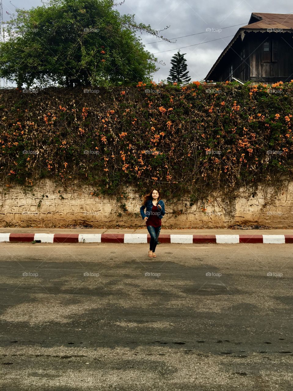 Funny Asian, Myanmar Girl Running Across Road in Kalaw, Myanmar