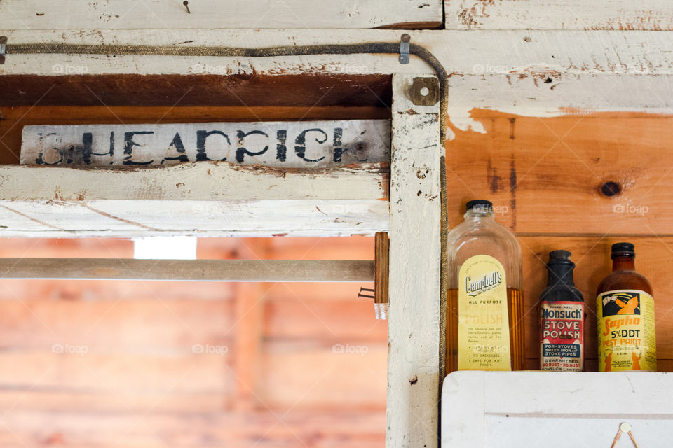 Old bottles and signs in a rustic cottage