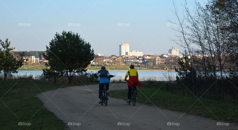 people riding on a bikes beautiful landscape lake view