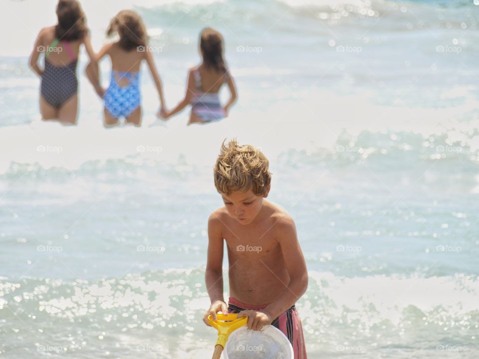 Boy standing at beach