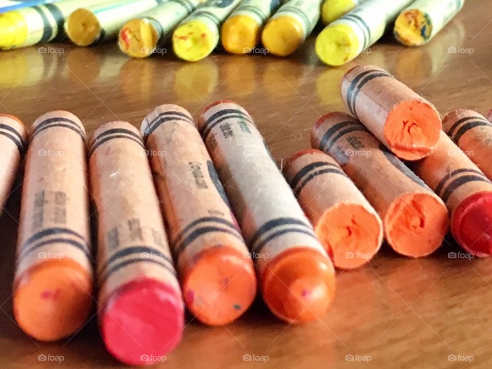 Crayons in red, orange and yellow tones. 