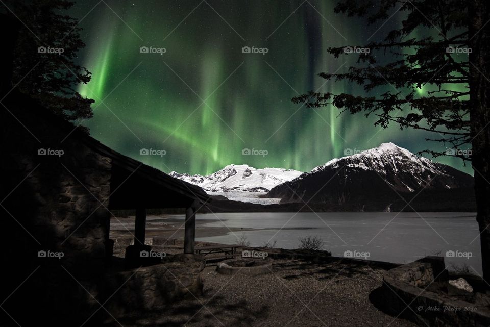 Aurora borealis dancing over glacier 