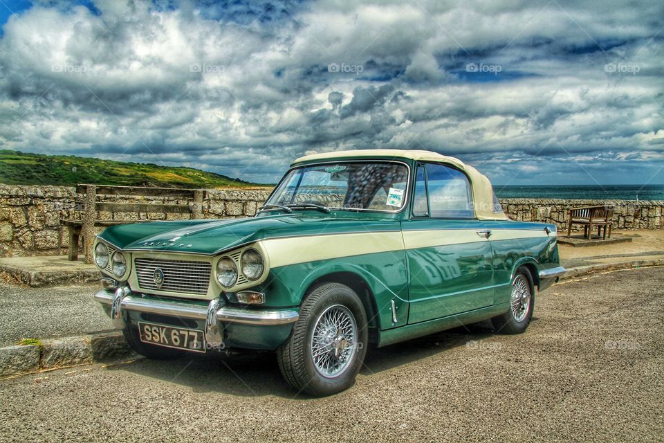 A classic Triumph Vitesse in mint condition parked at the seaside.