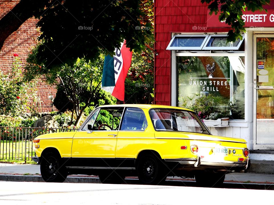 yellow car at the union street grill. This car stood out in bright sunshiny yellow against the backdrop of this case on a beautiful summer day.