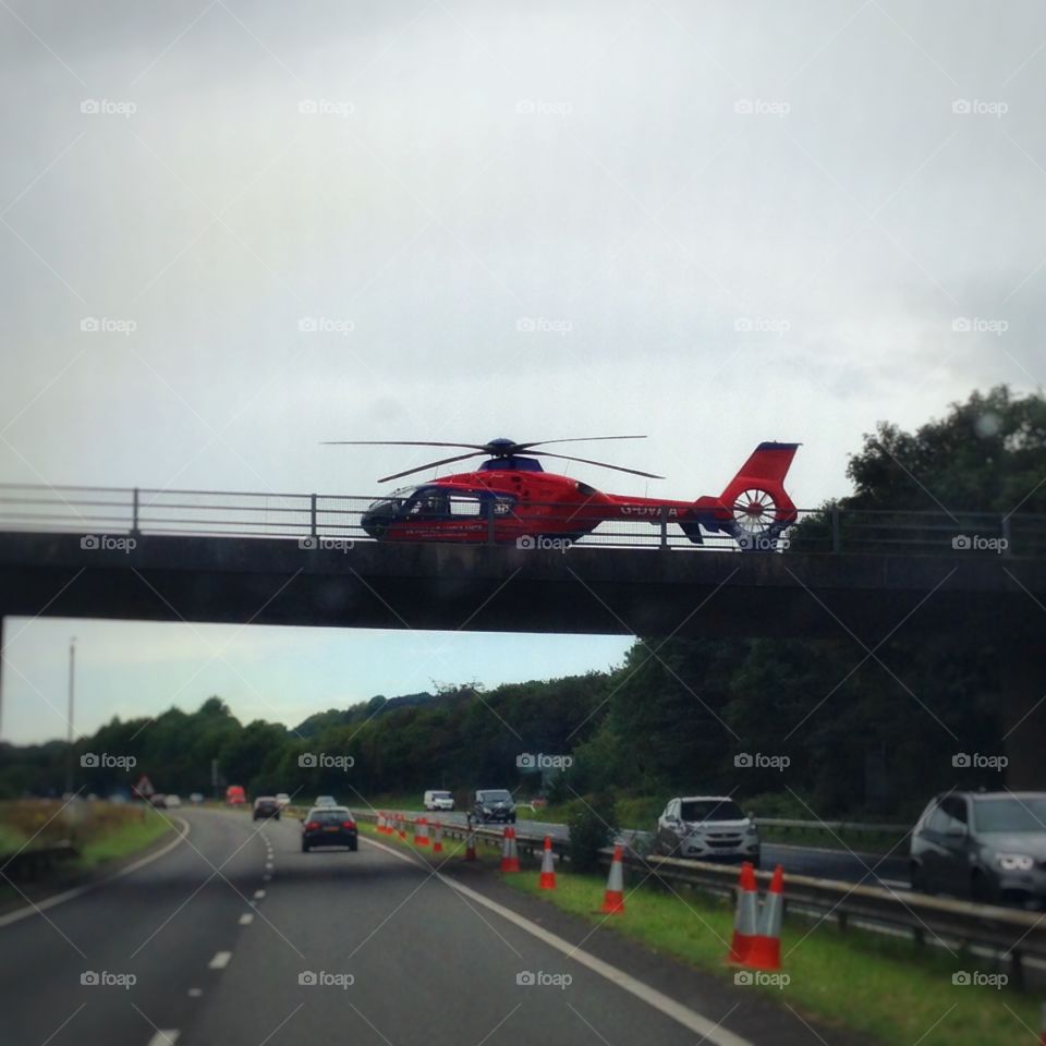 Bridge landing. Devon Air Ambulance landing on a bridge over the A38.
