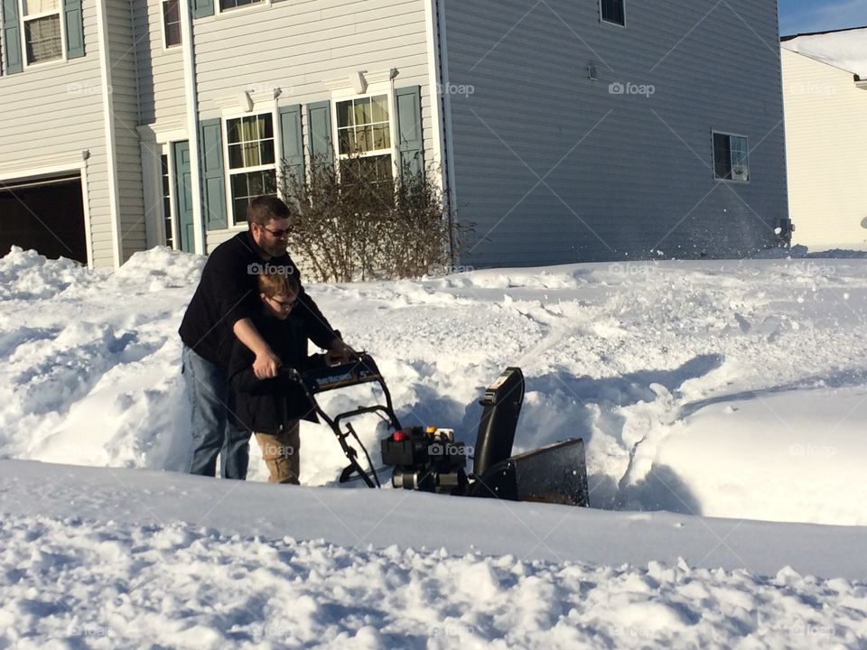 Raising up sons: my husband teaching our son how to use the snowblower when we had a big snow this winter. 