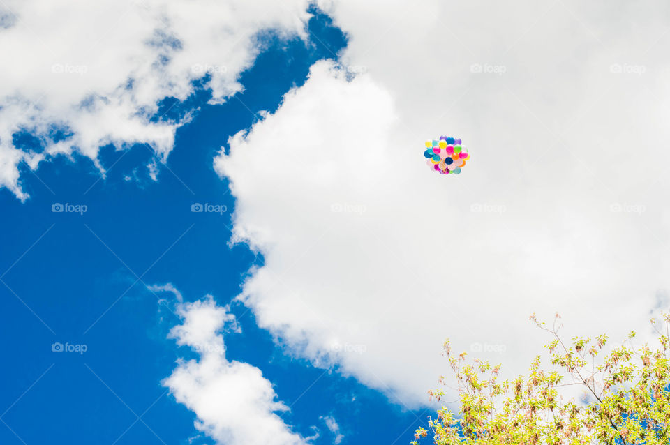 colorful baloons flying in the blue sky