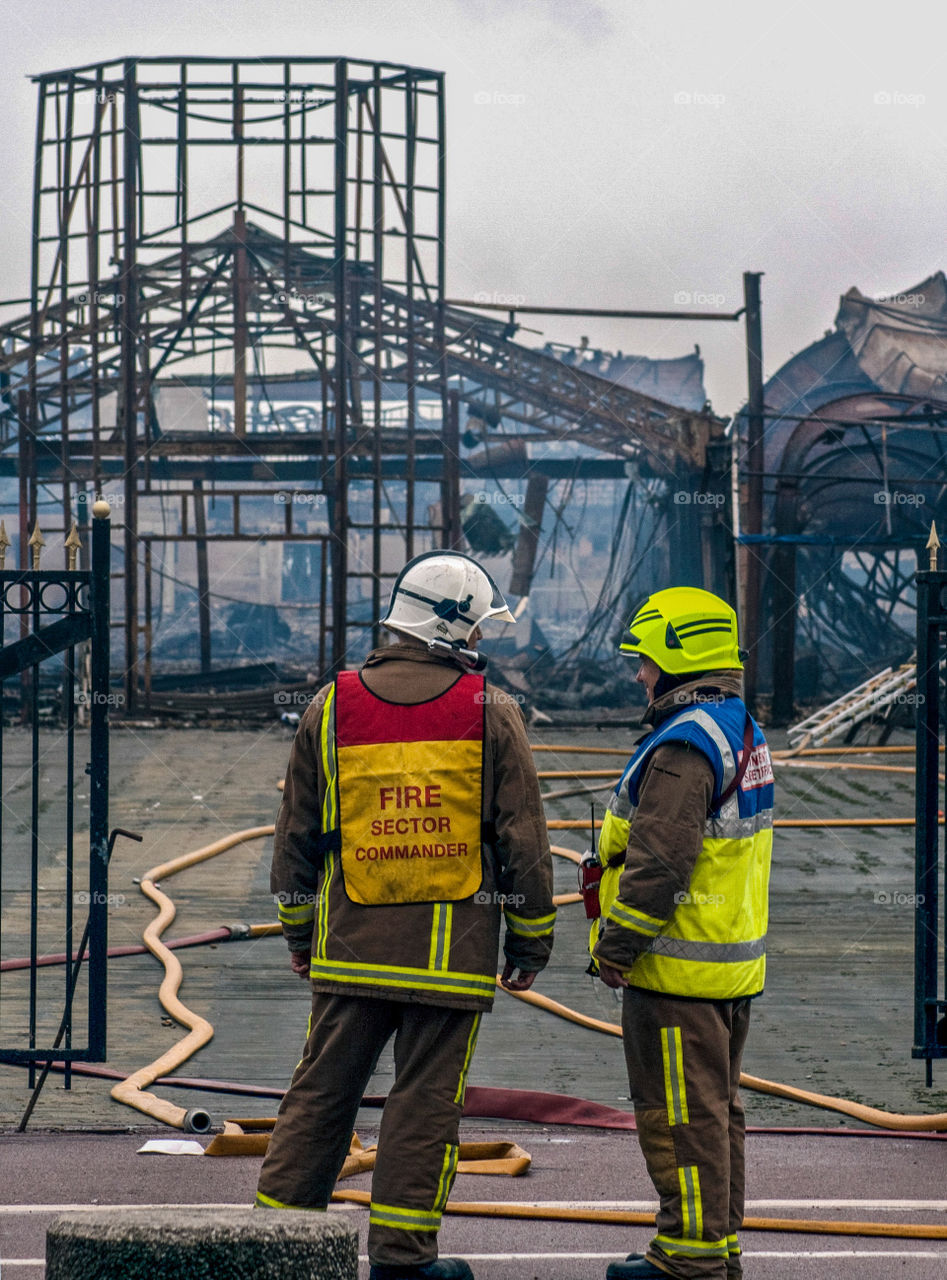 Fire fighters attend the aftermath of Hastings pier fire, October 2010, UK 