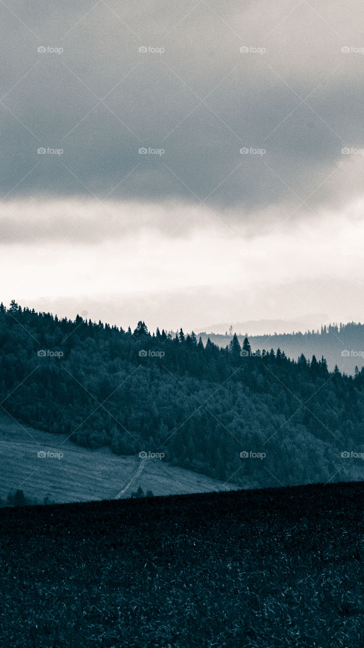 An inspiring mountain landscape. Tatry mountains in Slovakia. A beautiful wallpaper for smartphone screen. Monochrome blue abstract gradient with perspective.