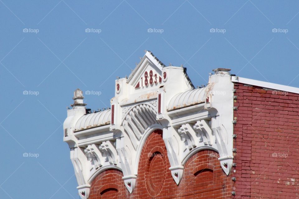 Architectural detail on the front of an historical building, built in 1883