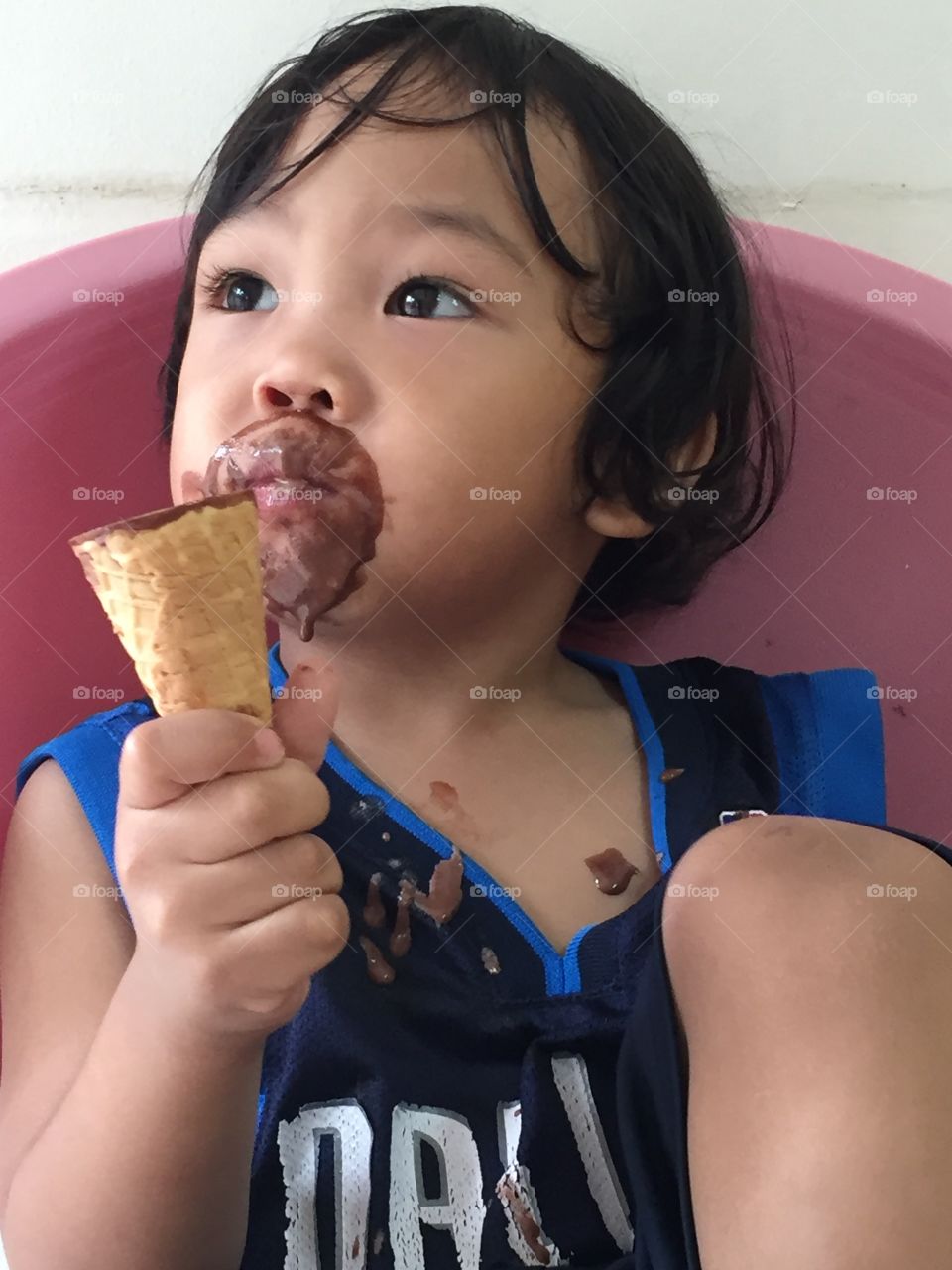 A 2 year old boy eating ice cream
