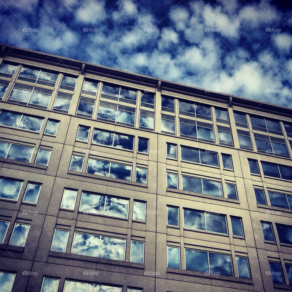 clouds reflecting off windows.