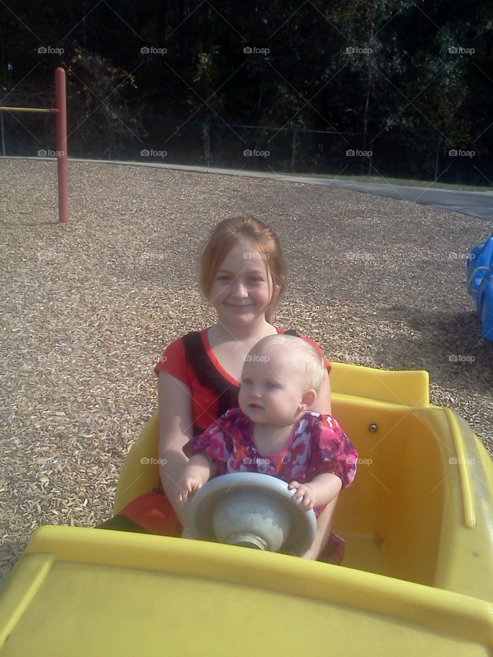 Driving at the park. Daughter's playing at park