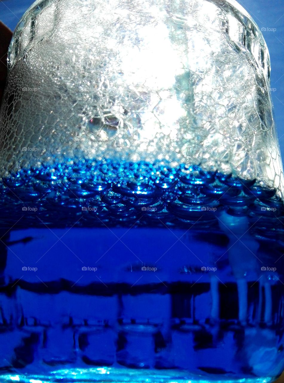 blue and white bubbles in glass