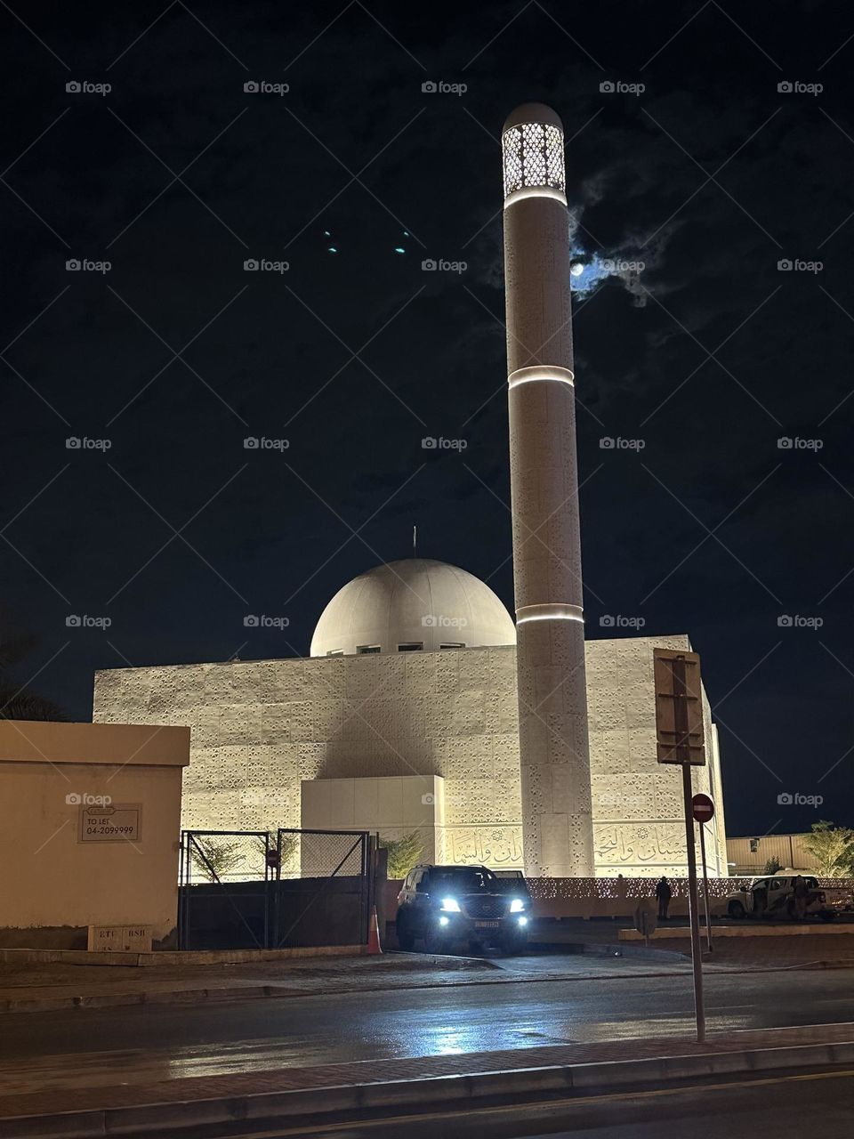 Mosque in a full moon in the sky of Dubai - beautiful architecture with parts of the Quran engraved in the walls - 