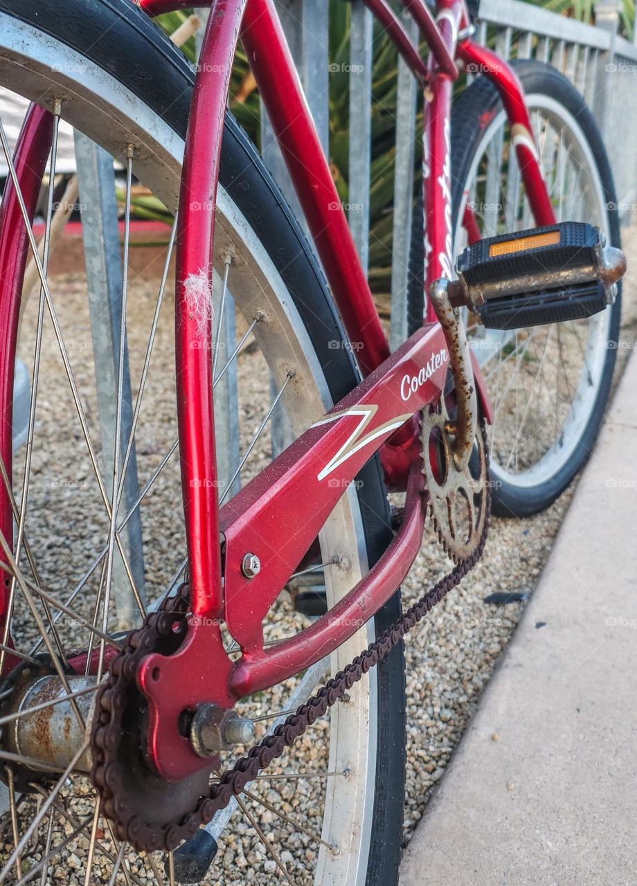  Abstract Vintage red bicycle along a fence